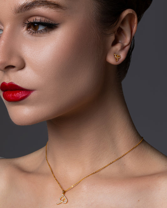 Gold earrings adorned with lab diamond featuring the letter H